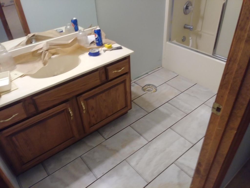 During. Floor repaired, new tile and vanity instal