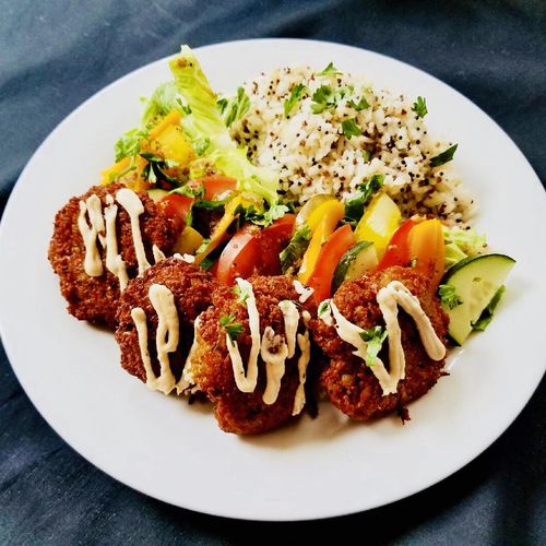 Vegan falafel platter with side red quinoa rice an