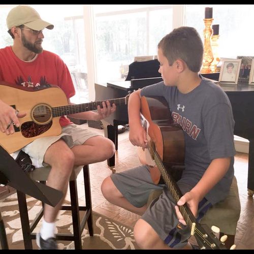 Craig with a beginner guitar student.