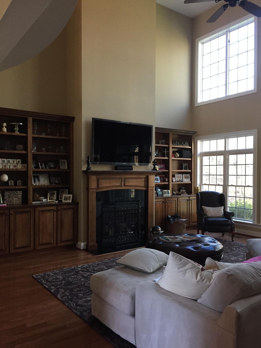 Another TV mounted above the fireplace with the eq
