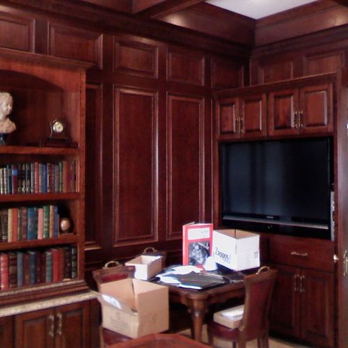 built in cabinets with wainscote and coffered ceil