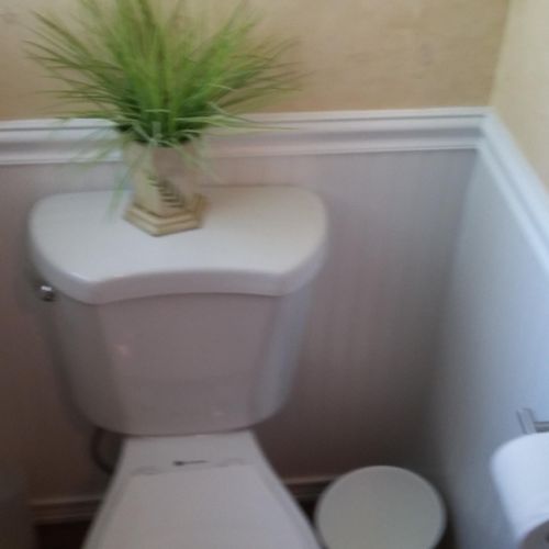 New toilet with ship lap wood trim on walls to fre