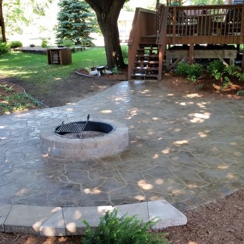 Faux natural stone patio with small sitting wall a