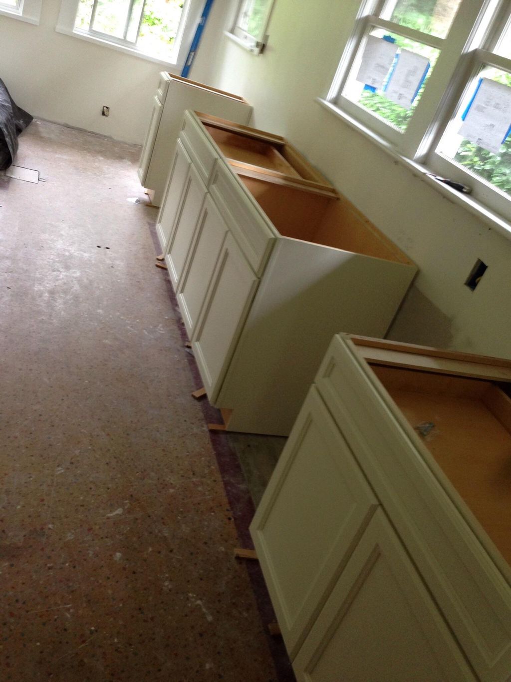 The start of a kitchen remodel. Installing cabinet