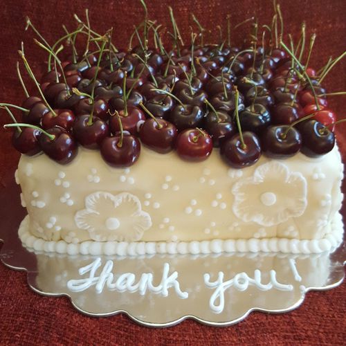 white cake with fresh cherry compote