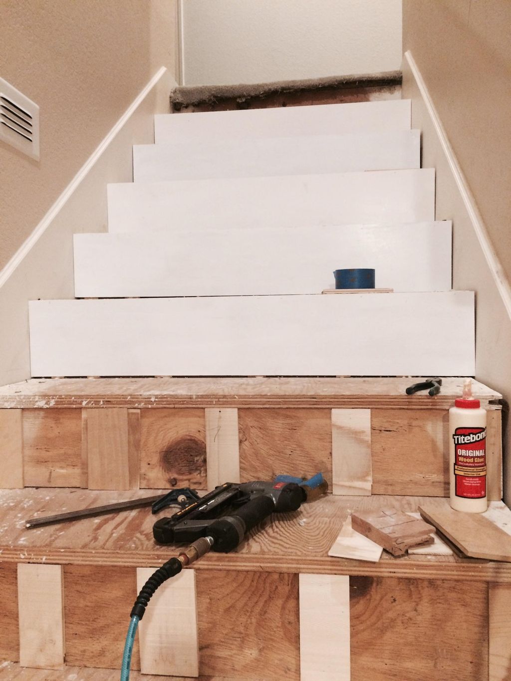 Putting on the white backboards for the stairs (ea