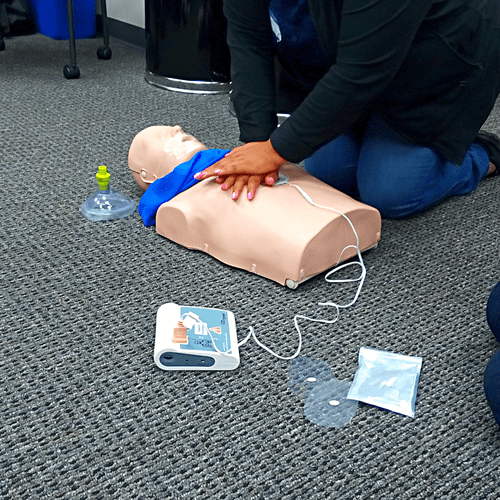 Student performing high quality compressions with 