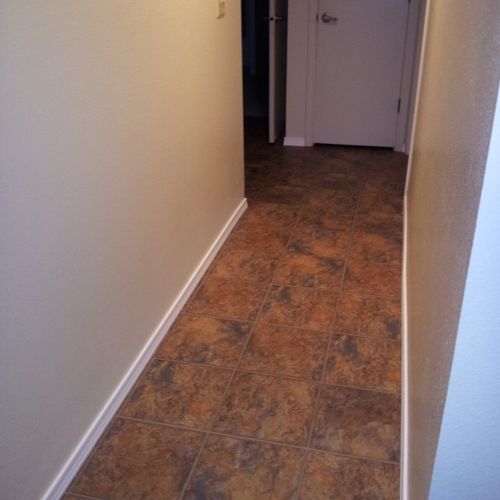 Vinyl floor in hallway, new baseboards, painted an