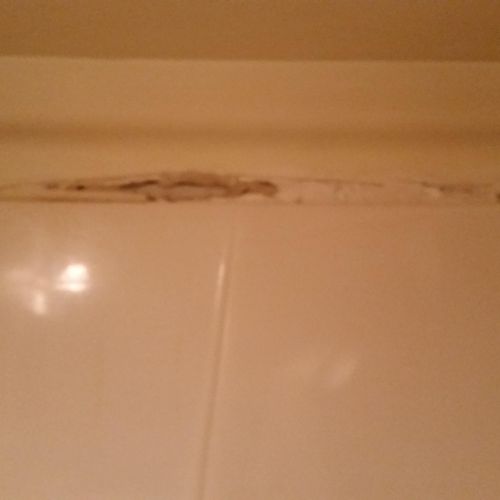 Old rotten mildew drywall above shower