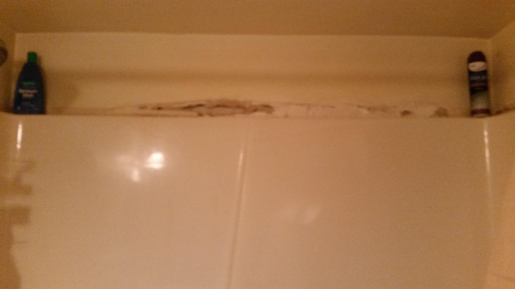 Old rotten mildew drywall above shower