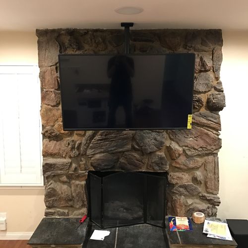 Ceiling Mounted TV In Front of Fireplace