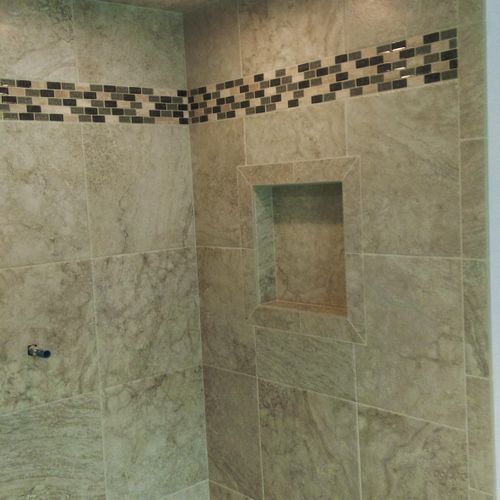shower build with footrest and Niche with mosaic f