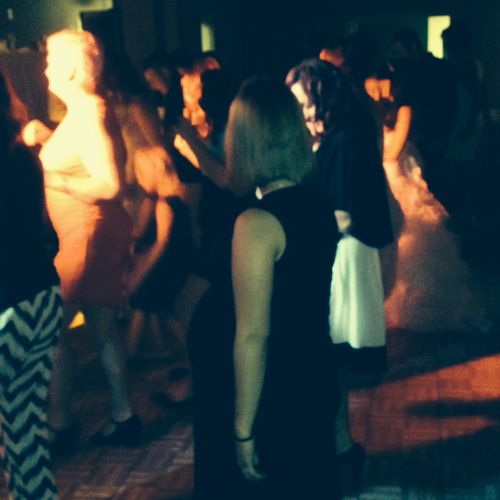 The crowd line dancing during a wedding reception 