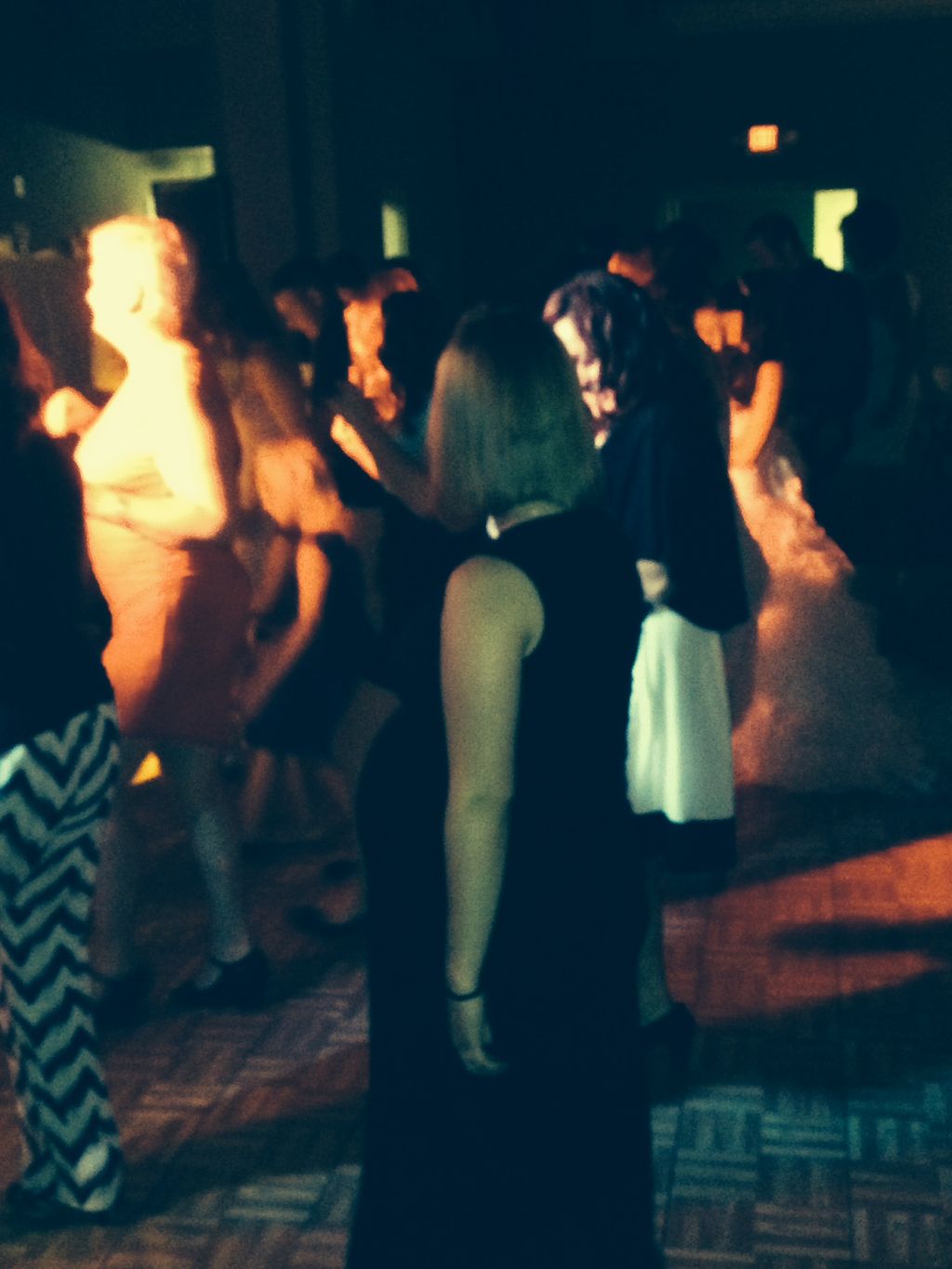 The crowd line dancing during a wedding reception 