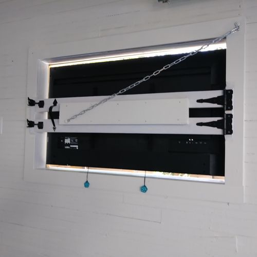 Outdoor tv mounted in wall w/ custom window