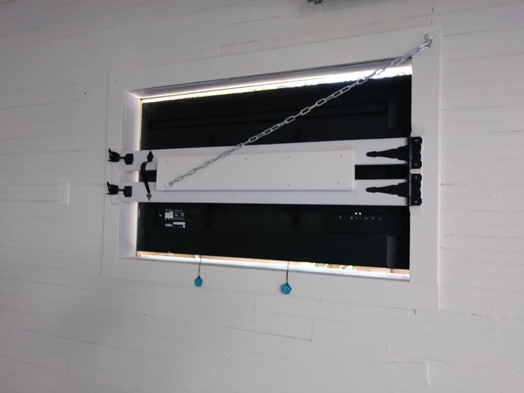 Outdoor tv mounted in wall w/ custom window