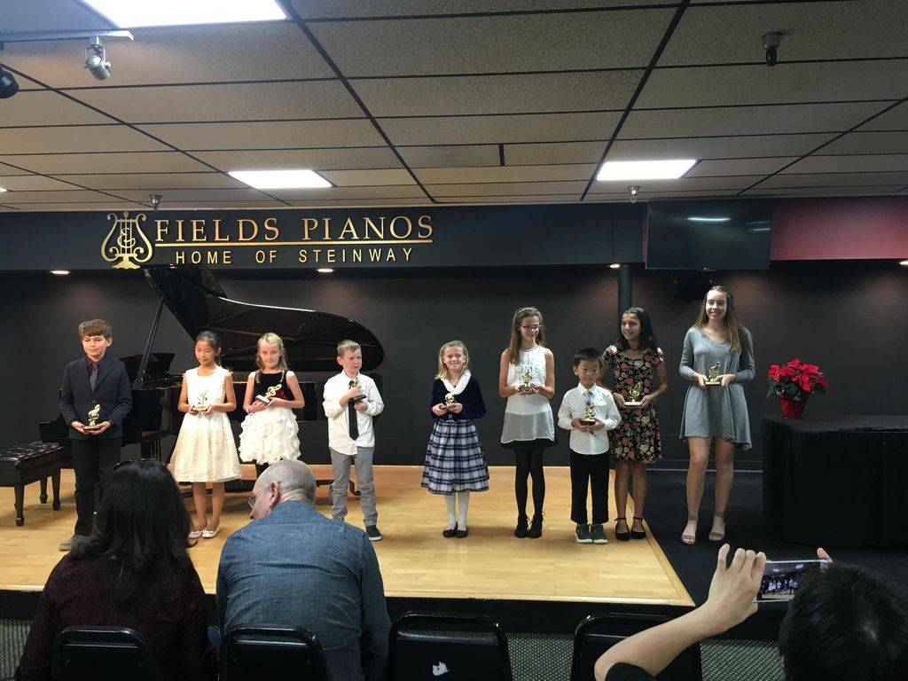 Performers holding their trophies after a recital