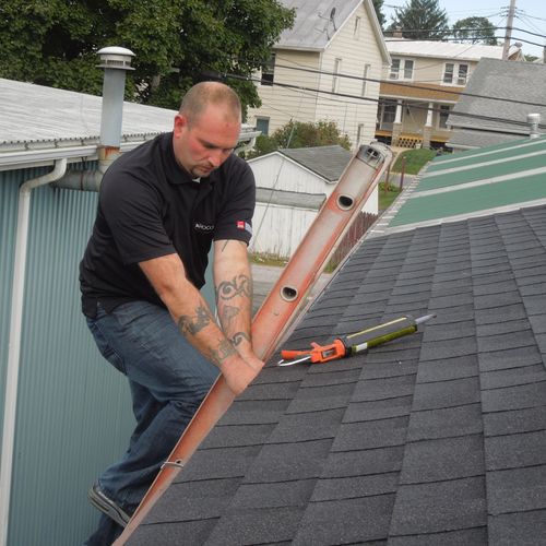 Our roofing tech is conducting an inspection. 