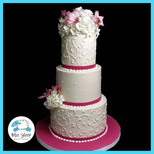 Three tiered classic buttercream wedding cake with