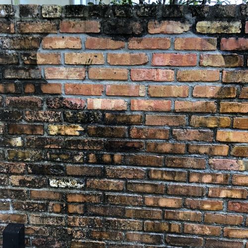 Pressure washing brick wall