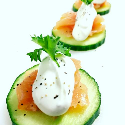 Smoked salmon on cucumber with dill cream.