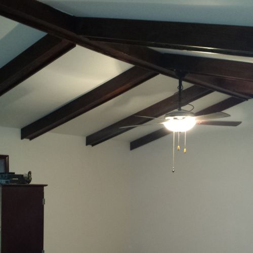 Installed and stained faux ceiling beams.