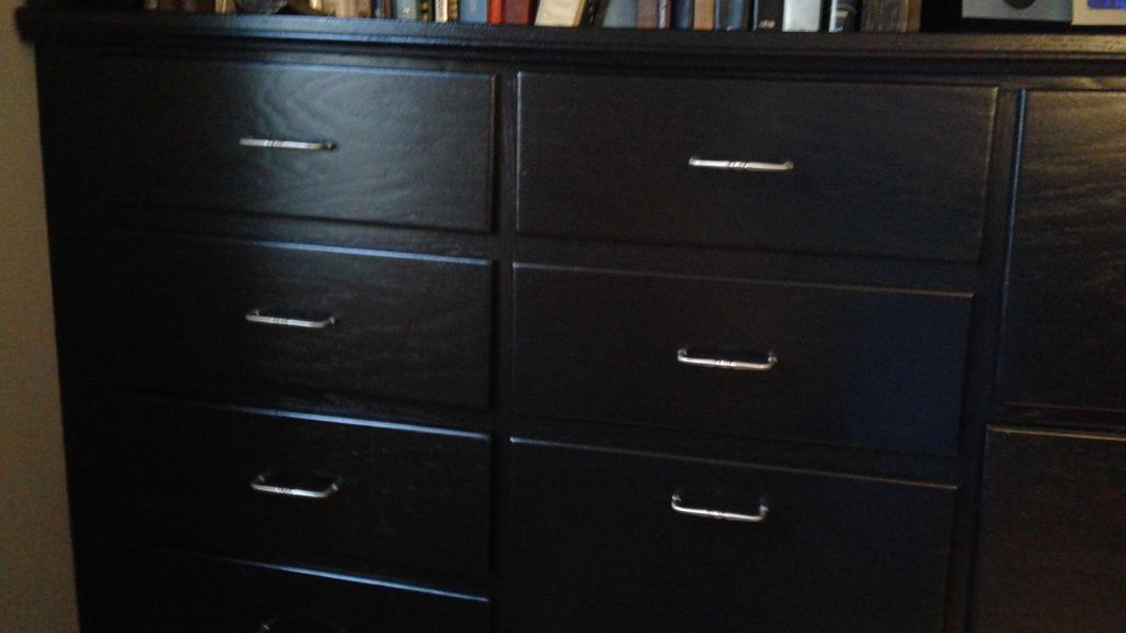 Refinished light oak cabinet/bookcase to black.