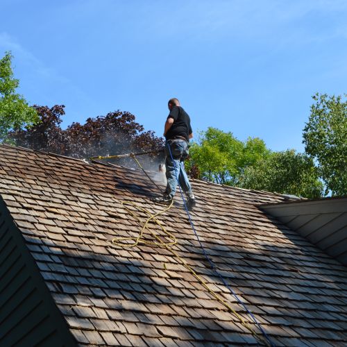 Stainng a cedar roof after cleaning and repairs