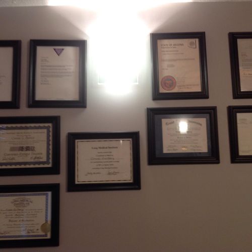 Degrees displayed on gym wall.