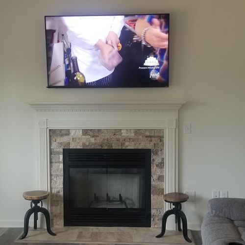 TV mount with cable boxes located in basement