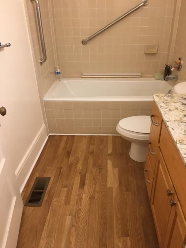 New hardwood floor installation in bathroom locate