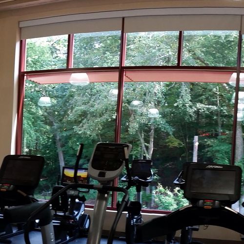 Panoramic view of fitness center with multiple han