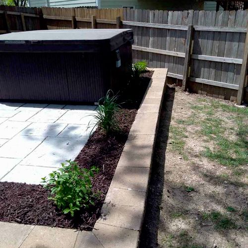 retaining wall around a hot tub with plantings