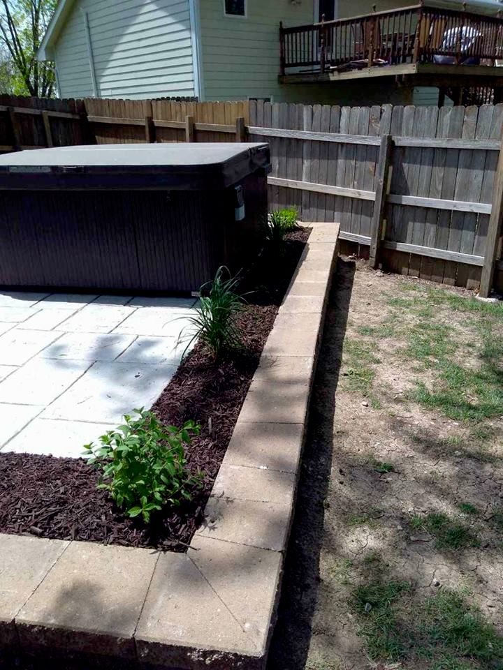 retaining wall around a hot tub with plantings