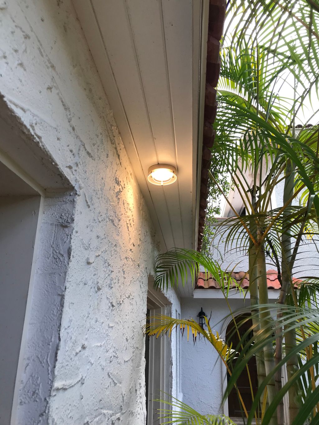 Installation of exterior LED flush mount light.  