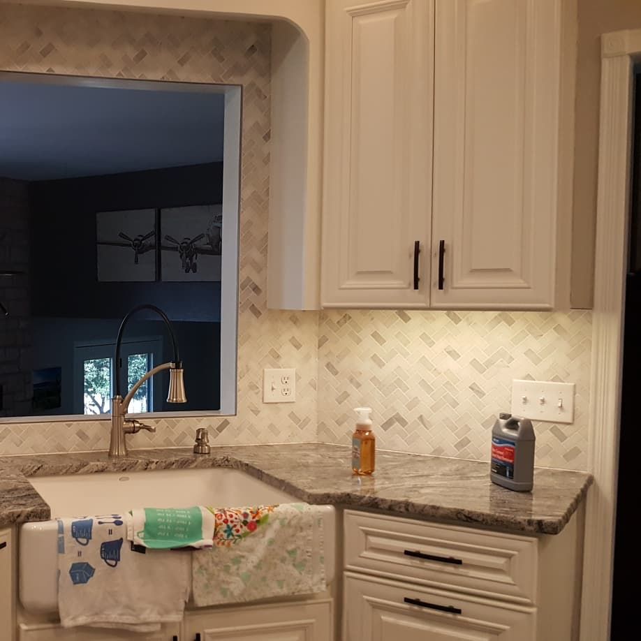Herringbone Splash with white marble mosaic. 