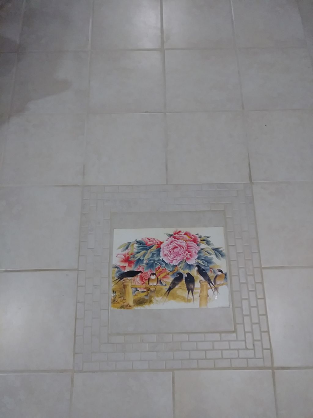 detail of 700 sf tile flooring install in basement
