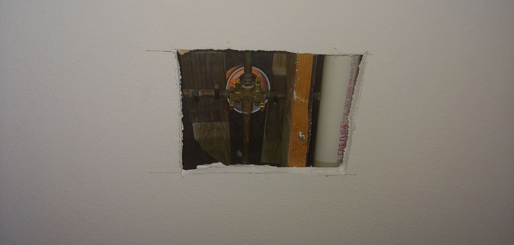cut out wall to install new tub manifold