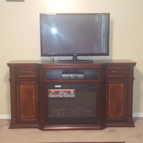 Carl assembled a media center with a fireplace for