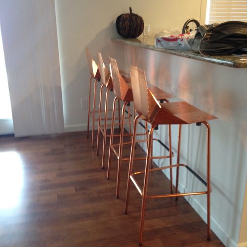 Chase assembled four metal bar stools for us as we