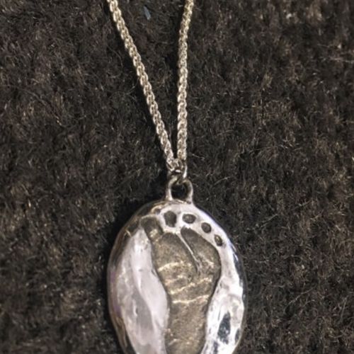 I had a custom necklace made with the imprint of m