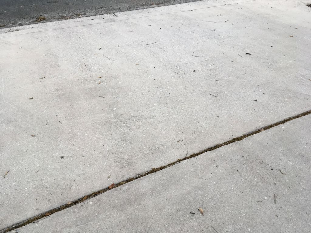 Power washed driveway, sidewalks, curbs, and entry