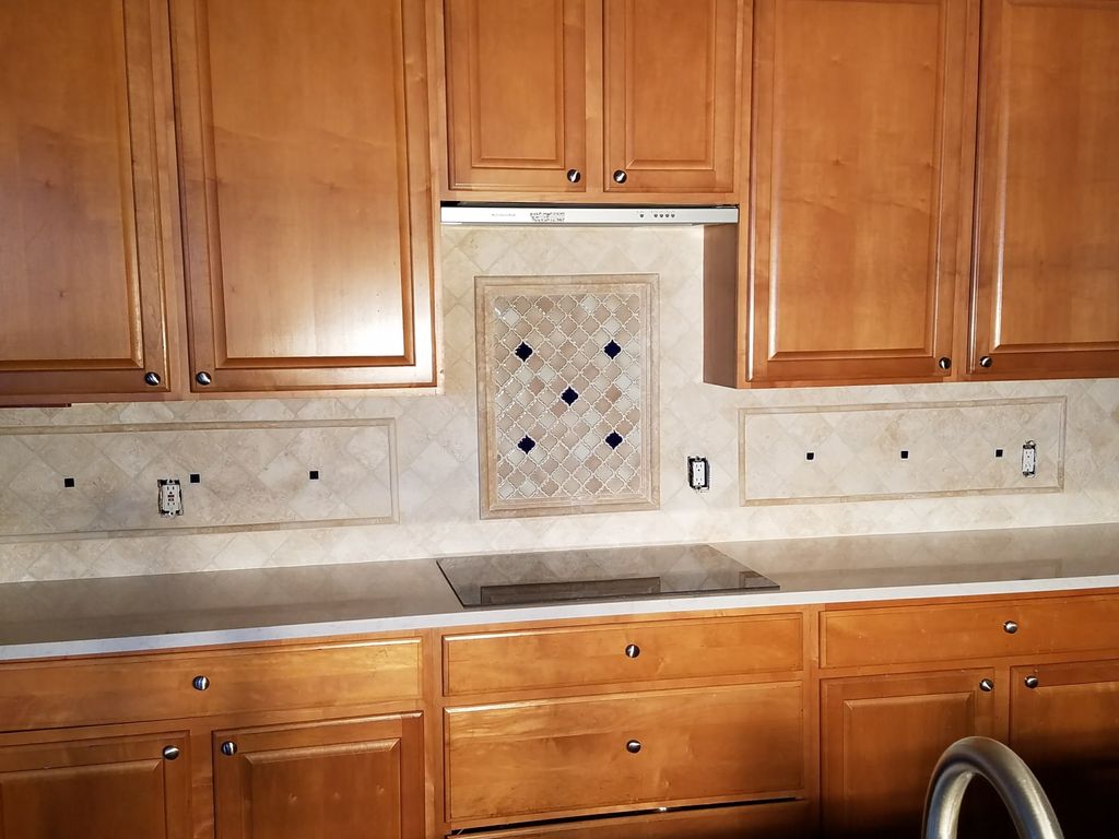 James started work on our Travertine backsplash on