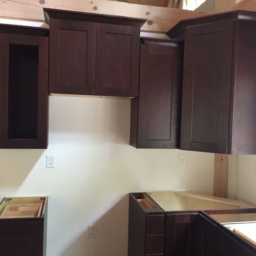 Installed kitchen cabinets with crown molding. Ple