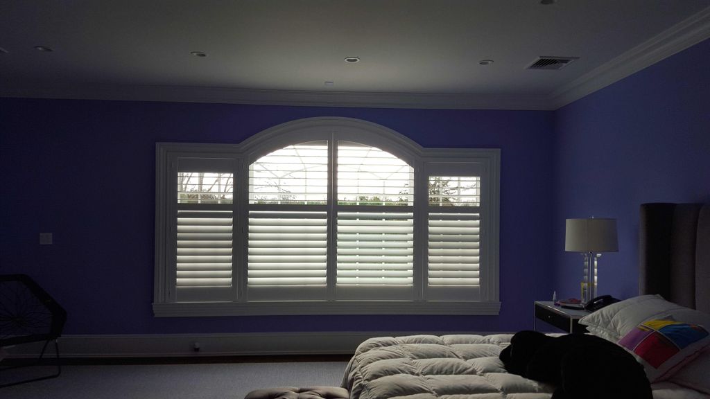 These custom made shutters fit this challenging wi