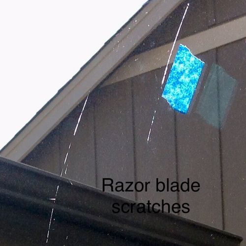 Razor blade scratches on sliding glass door.  Very
