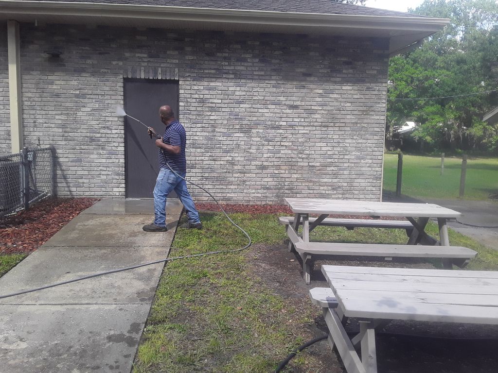 Antonio rinsing off the soft wash from the bricks