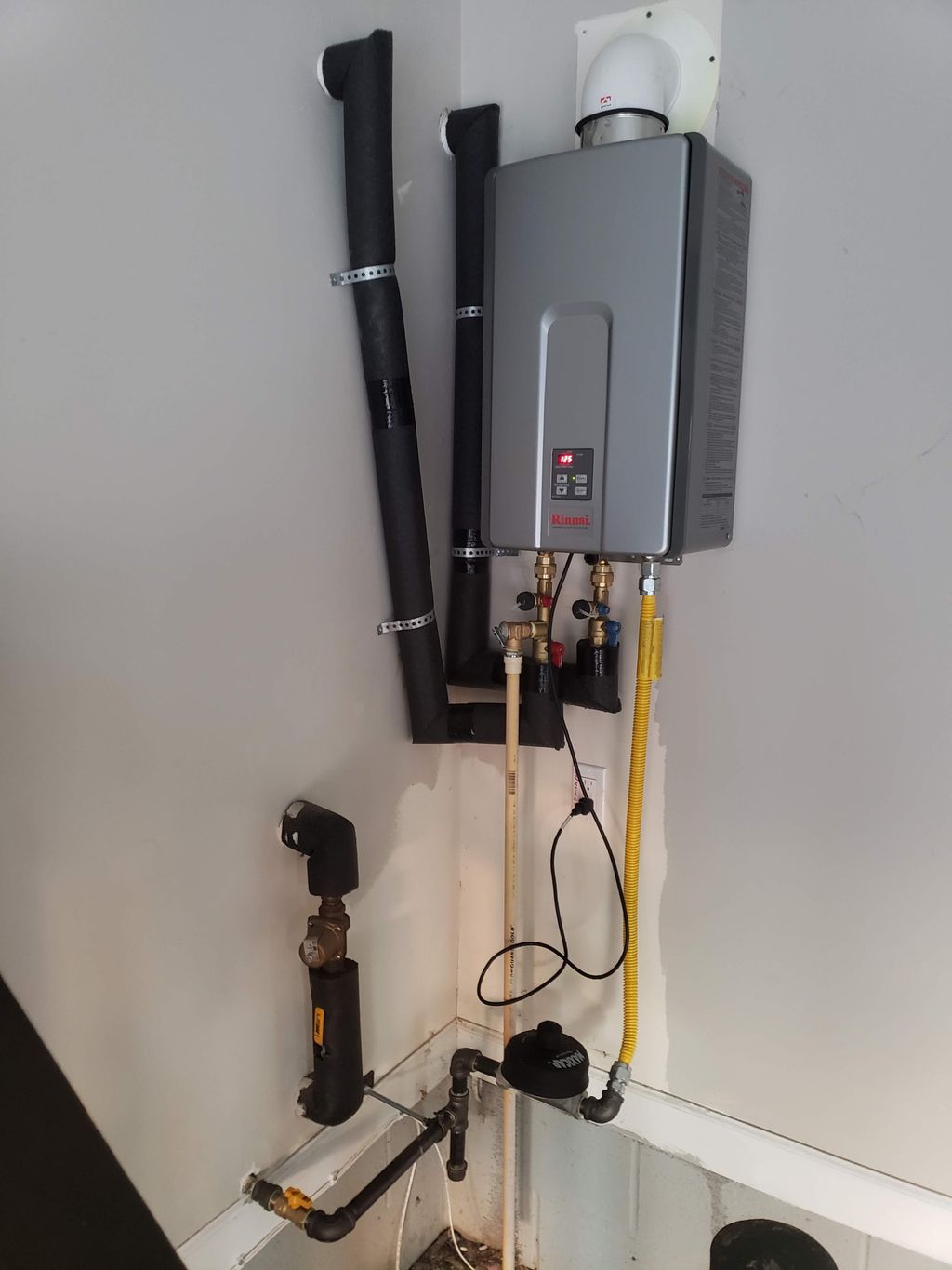 Garage interior mounted Rinnai tankless water heat