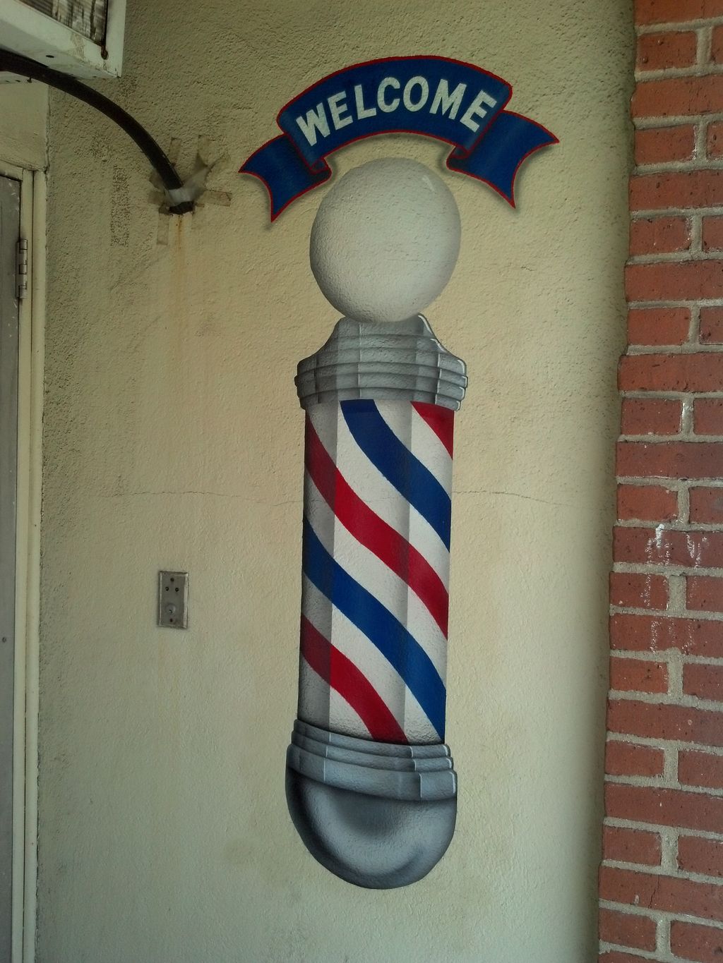 Barber Pole painted on outside wall.