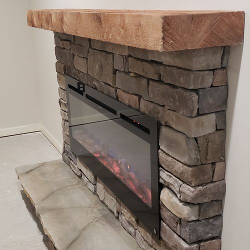 LED fireplace in stone and cedar mental